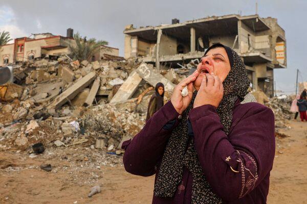 A Palestinian woman reacts as people inspect the damage following Israeli strikes on Rafah, on the southern Gaza Strip, on Monday. Picture: Mohammed Abed/AFP via Getty Images