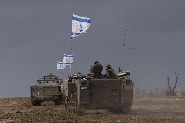 Israeli soldiers manoeuver armored military vehicles along Israel's border with the Gaza Strip. Picture: AP Photo/Ohad Zwigenberg