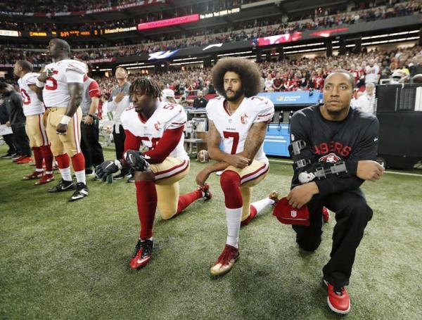 Former San Francisco 49ers quarterback Colin Kaepernick kneels during the natio<em></em>nal anthem.