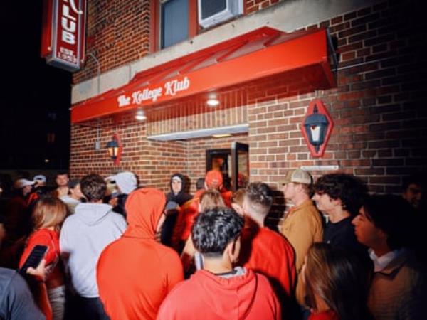 Students stand outside bar