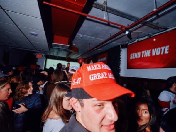 Man in red Maga hat at party