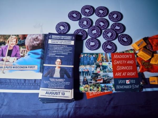 Pamphlets and badges on table