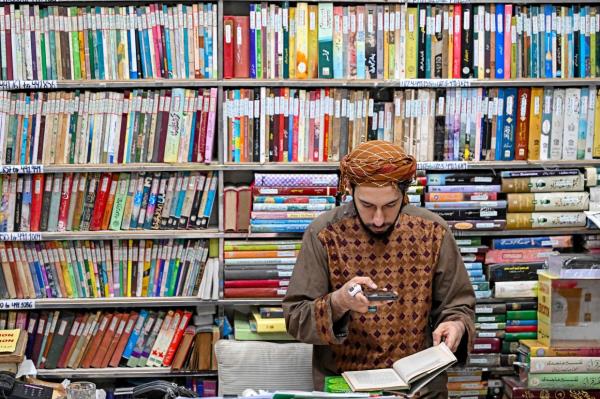 A student taking pictures of an Urdu book at the Hazrat Shah Waliullah public library, in Urdu Bazar in the old quarters of Delhi. Photo: AFP 